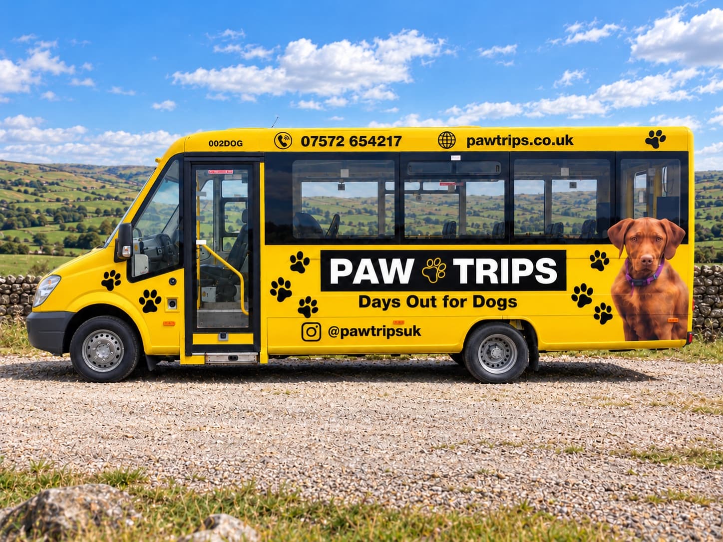 The PawTrips bus side on, showing the wrap: wordmark, Days Out for Dogs, paw prints and the dog graphic