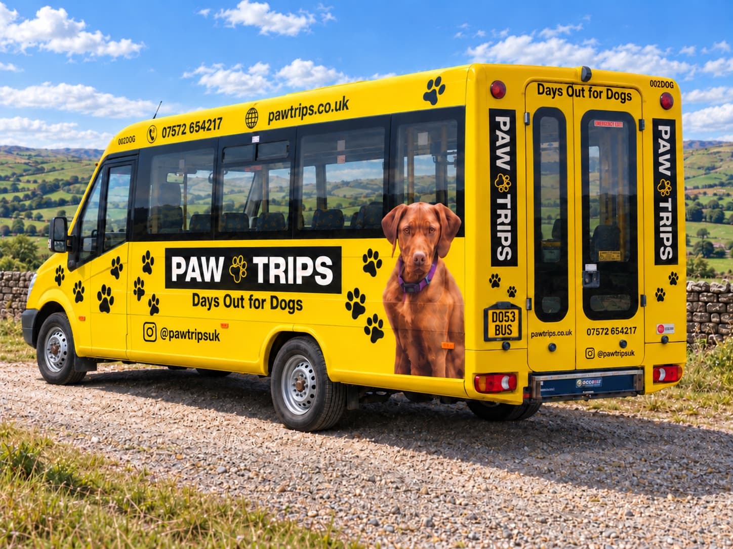 The PawTrips bus from the back, with the rear doors, phone number and web address