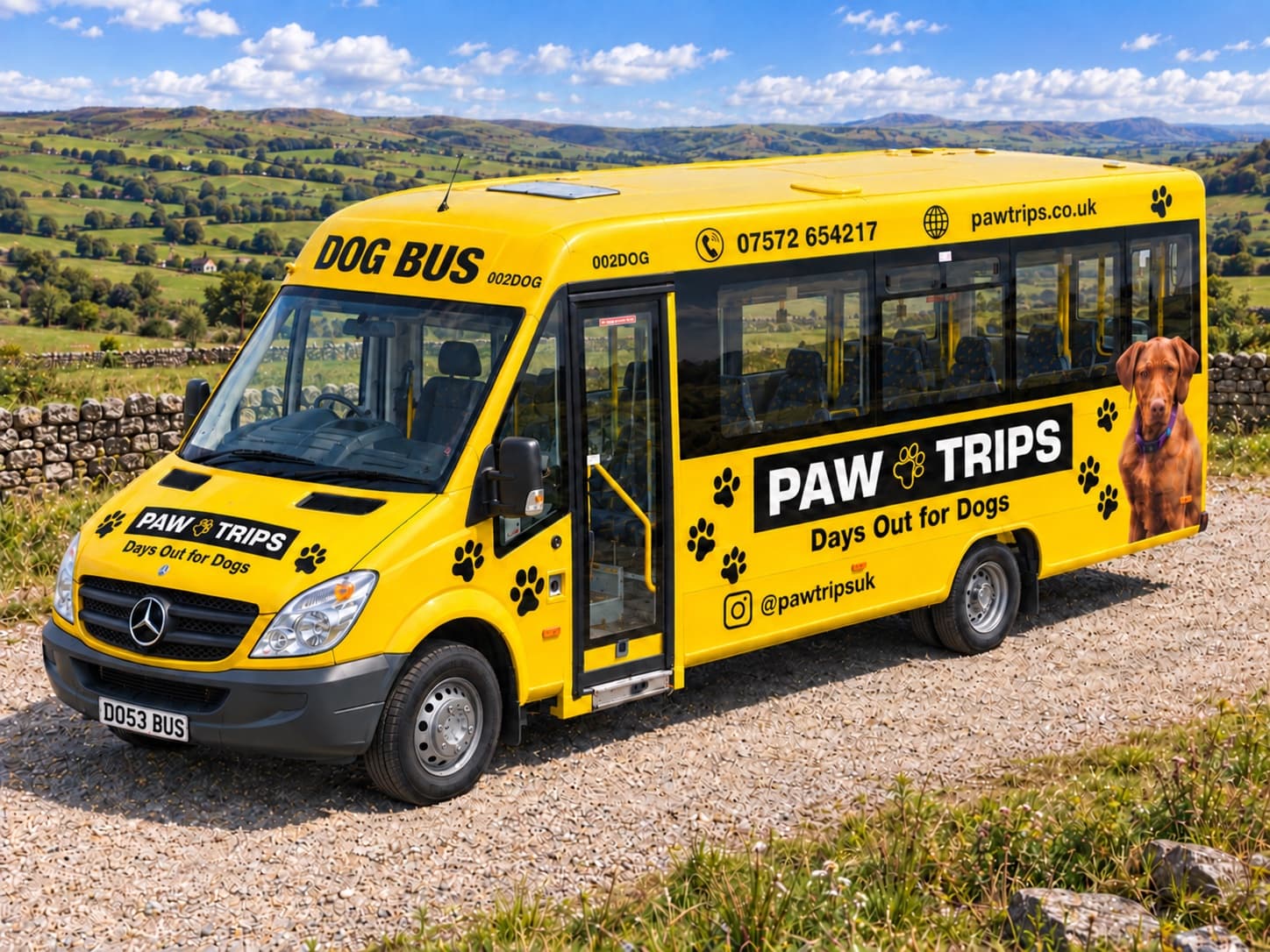 The PawTrips bus from above the front, on a gravel track with stone walls and green hills behind
